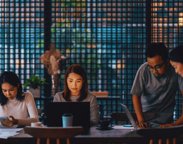 Person working on a laptop in a modern collaborative workspace
